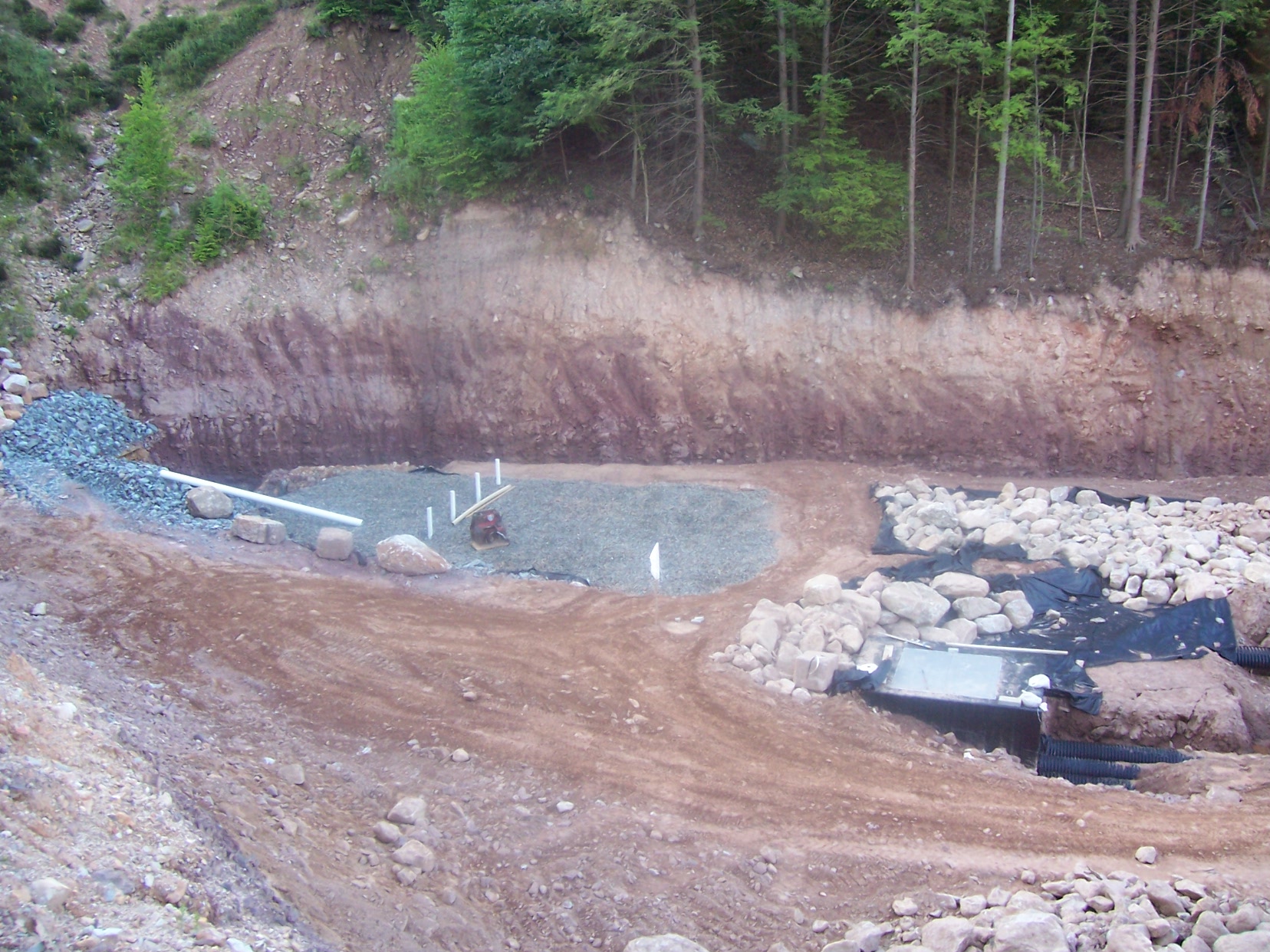 8 24 05 view of treatment system intake with rock filter and rock lined channel
